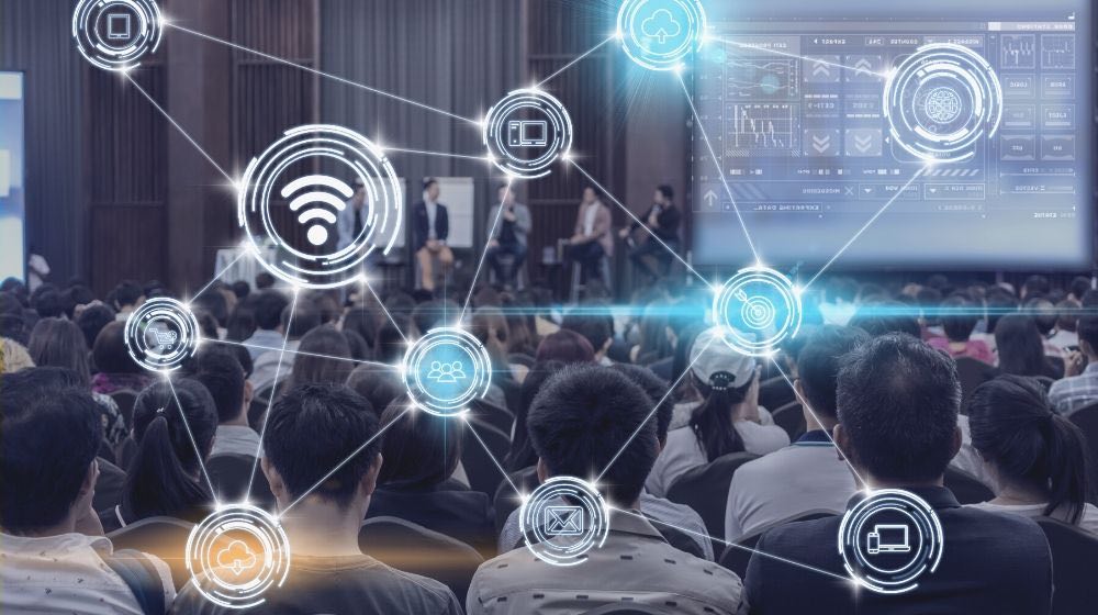 Wireless communication connecting of smart city internet of things technology over abstract blurred photo of conference hall | channel partners las vegas 2020 | channel partners 2020 conference and expo | featured