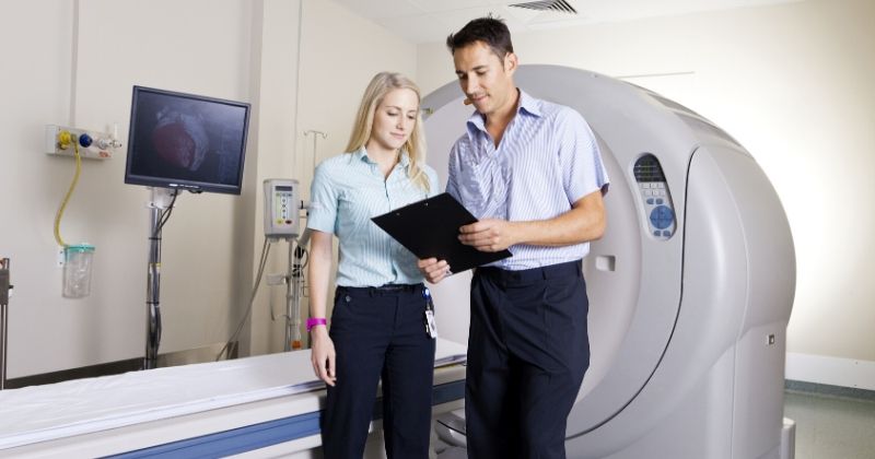 CME Science Breast Imaging A-Z 2020 Las Vegas | young doctor nurse standing front mri | CME Science Breast Imaging A-Z 2020