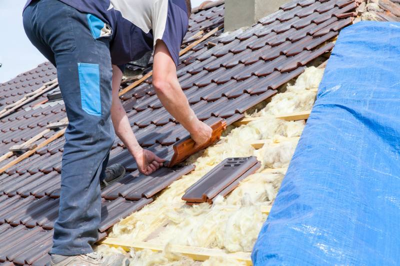 International Roofing Expo 2021 2021 | Man laying tiles on the roof | What Industry Does International Roofing Expo Serve