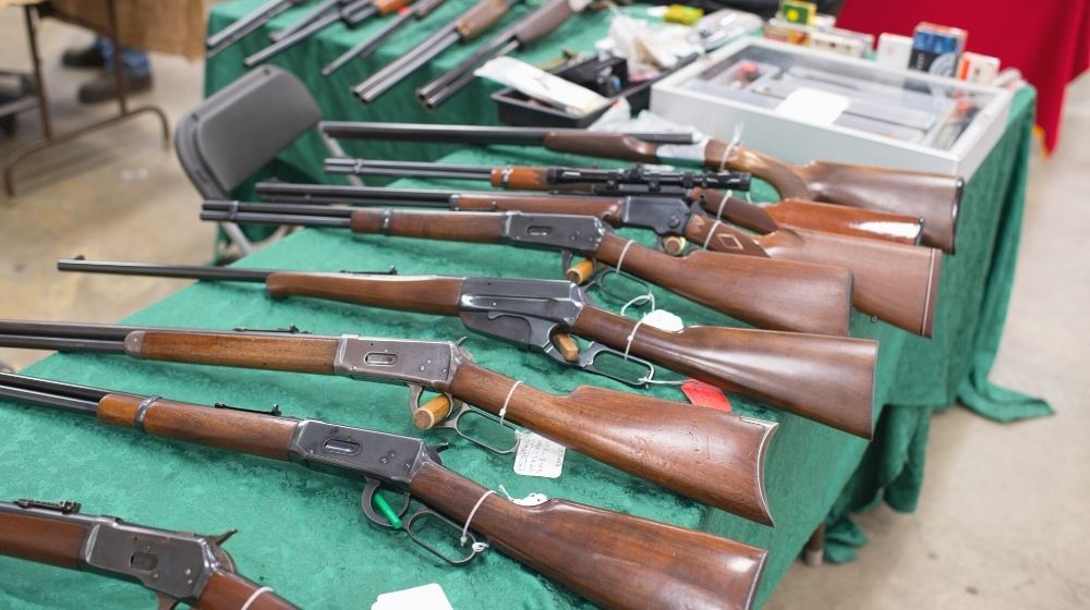 Image of rifles on a table at a gun show | western trails gun and knife show 2020 (september) | featured