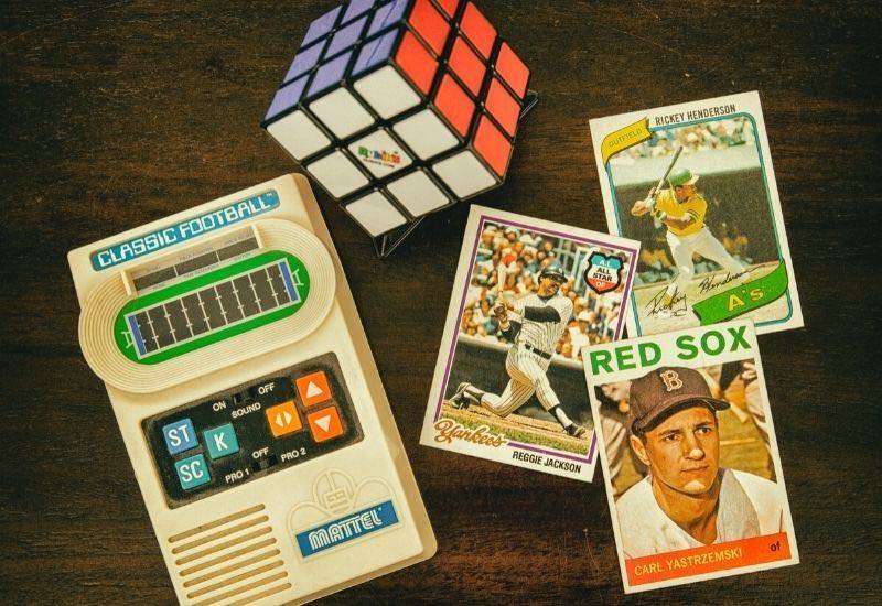 Three baseball trading cards beside rubiks cube and classic football handheld console | the industry summit 2020 (virtual event)