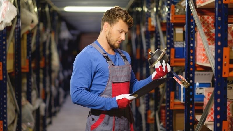 worker on automotive spare parts warehouse | AAPEX 2021 | Automotive Aftermarket Products Expo