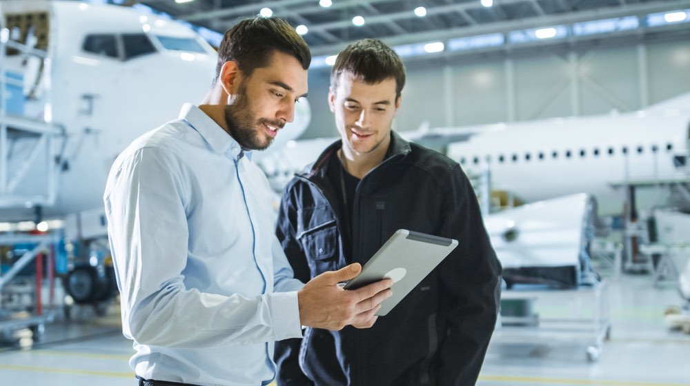 Aircraft maintenance worker and engineer having conversation | nbaa business aviation convention & exhibition| featured - ss